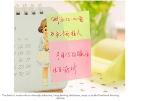 Pink and green sticky notes applied to a calendar showing easy tear and re-stick use