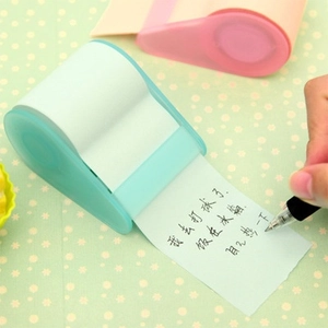 Creative roll-on sticky notes with dispenser and handwriting example on desk