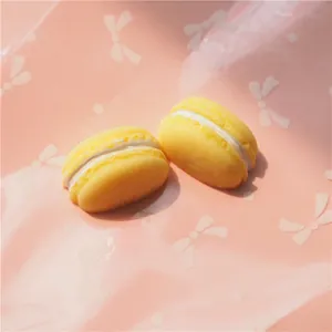 Macro detail of realistic yellow resin macaron charms for DIY phone case decoration