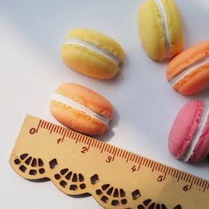 Miniature 20mm resin macarons in assorted colors on a vintage scale for DIY crafts