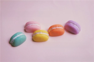 Detailed view of colorful resin macaron charms for DIY phone cases and craft accessories