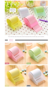 Macro detail of four-color roll sticky notes with transparent dispensers for office use