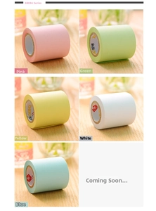 Macro detail of pastel adhesive memo tape rolls on light wood desk with holder