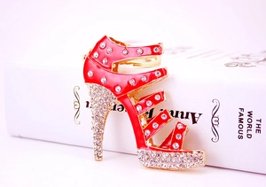 Macro shot of red high heel keychain with sparkling crystals and gold metal ring