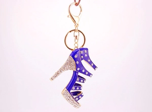 Macro shot of a blue enamel high heel keychain with sparkling rhinestones and gold plating