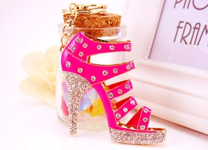 Detail of fuchsia rhinestone high heel keychain with gold metal buckle and crystals