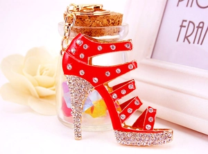Close-up of red enamel high heel keychain with sparkling crystals and golden metal clasp