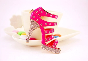 Detailed view of pink rhinestone high heel keychain with gold metal plating and crystal accents