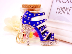 Detailed shot of a luxury blue crystal high heel shoe keychain with gold plating accents