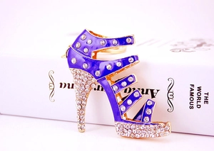 Detailed macro view of purple rhinestone high heel shoe charm with sparkling gold plating