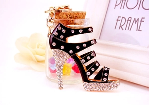 Detail of creative black high heel keychain featuring sparkling rhinestones and gold ring