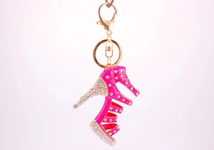 Macro view of pink rhinestone high heel keychain with gold lobster clasp and metal details
