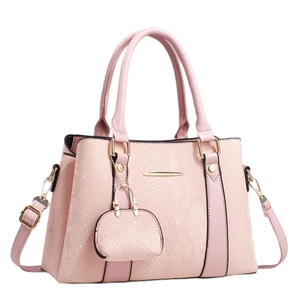 Elegant pink snake textured crossbody handbag with mini pouch charm and gold hardware