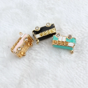 Detailed view of colorful enamel bus charms with rhinestones for DIY jewelry
