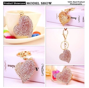 Macro detail of heart-shaped keychain with sparkling crystals and gold-tone hardware