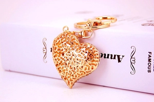 Macro shot of gold-plated hollow heart keychain with rhinestones and lobster clasp
