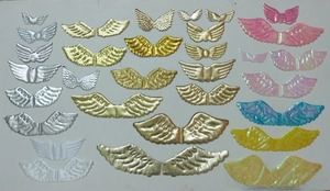 Detailed view of colorful angel wing plastic accessories for Christmas cake and DIY crafts