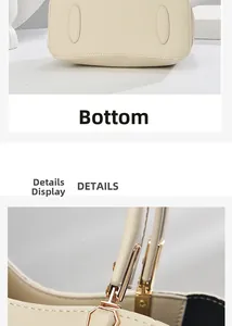 Detailansicht der cremefarbenen Ledertasche mit goldenen Beschlägen und flachem Boden
