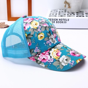 Detailed close-up of floral print canvas and breathable mesh back on summer baseball cap