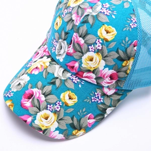 Close-up of bright blue mesh baseball cap with vibrant yellow and pink floral prints