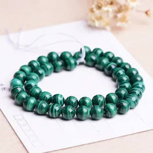 Natural malachite round beads for jewelry making with unique green striped patterns