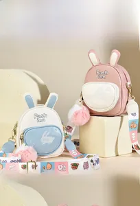 Detail of soft leather rabbit backpack with embroidered fashion logo and plush pompom