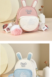 Detailed view of children's faux leather rabbit backpacks with cute embroidery and pom-pom charms