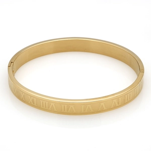 Detail view of gold titanium steel bangle with polished Roman numeral engravings