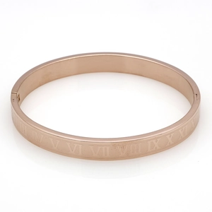 Close-up of rose gold Roman numeral bangle with high-polished finish and side clasp