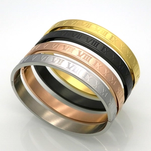 Detail of four titanium steel roman numeral bracelets in gold, silver, rose gold and black