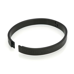 Close-up of matte black titanium steel bracelet with engraved Roman numeral details