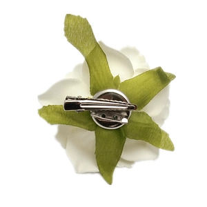 Back view of white artificial rose hair clip and brooch with metal duckbill clip