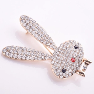 Close-up of golden rabbit head brooch with clear rhinestones and black crystal eyes