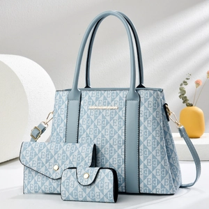 Light blue 3-piece tote bag set with geometric print and matching pouches on white background