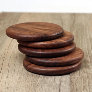 Set of 5 round dark walnut wood coasters with natural grain and smooth round edges