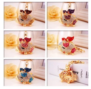 Detailed collection of creative flying pig keychains with rhinestones in six vibrant colors