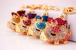 Close-up of sparkling rhinestone flying pig keychains in multiple vibrant colors