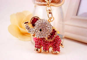 Close-up of golden elephant keychain with sparkling white and pink rhinestones