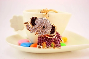 Close-up of cute elephant keychain with sparkling purple and clear rhinestones