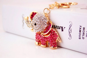 Close-up of sparkling pink rhinestone elephant keychain with gold finish and link chain