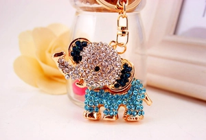 Detailed view of golden elephant keychain with sparkling blue and clear rhinestones