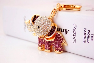 Detailed view of sparkling purple and white rhinestones on golden elephant keychain