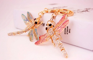 Detail of colorful dragonfly keychains with sparkling rhinestones and golden alloy finish