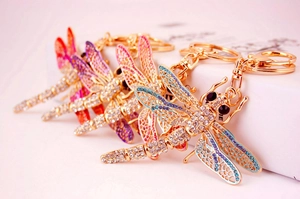 Detail of dragonfly keychain with colorful enamel wings and sparkling rhinestones