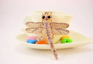 Macro shot of dragonfly keychain with gold plating and sparkling crystal rhinestones