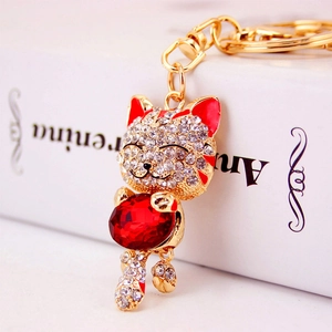 Golden lucky cat keychain with white rhinestones and large red crystal for handbag charm