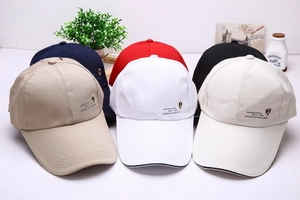 Close-up of baseball caps in various colors with Genuine Sports shield logo
