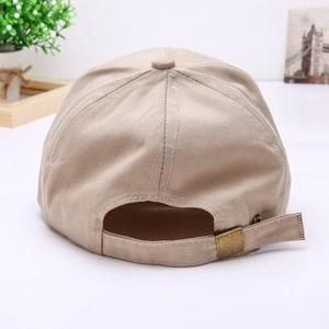 Detail view of the beige baseball cap's adjustable back strap and vintage metal buckle