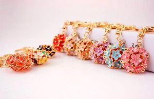 Detail of colorful hollow flower keychains with gold plating and spring snap hooks