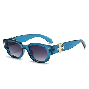 Blue oval sunglasses with golden eagle accents and purple gradient lenses seen at 45 degrees